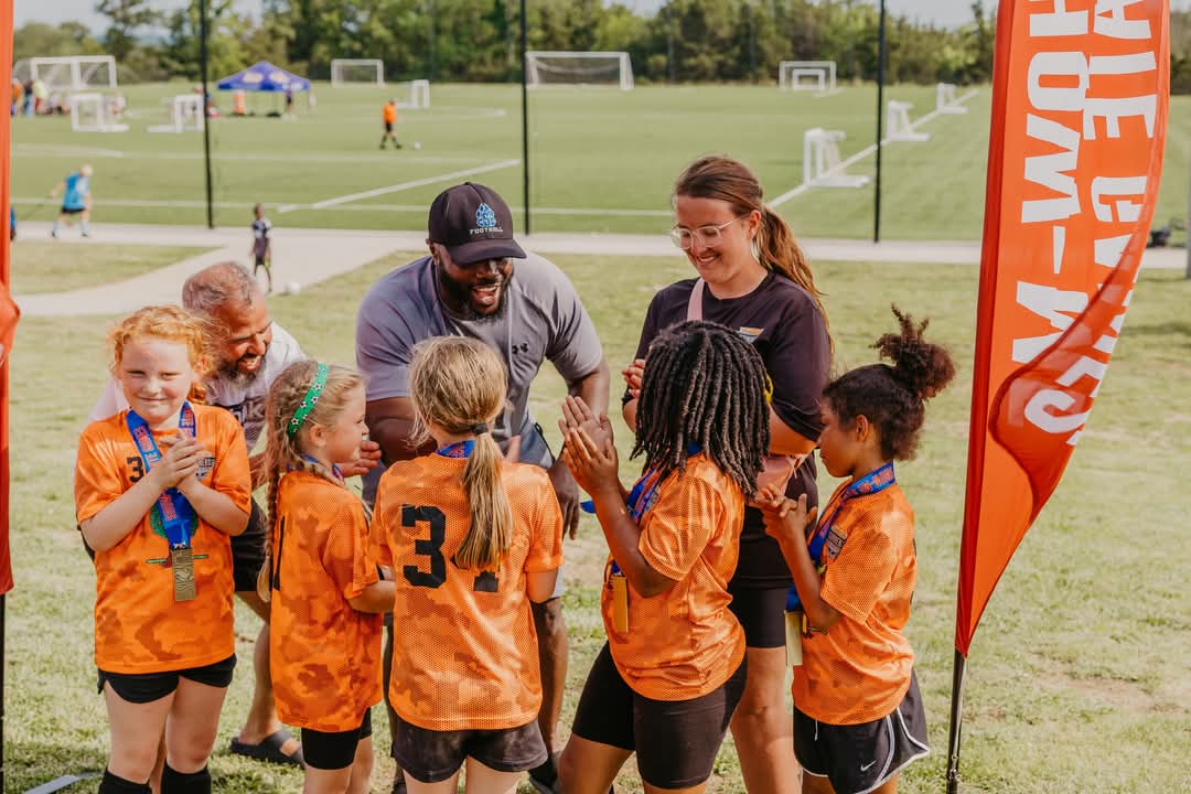 Andre on soccer field encouraging his team.