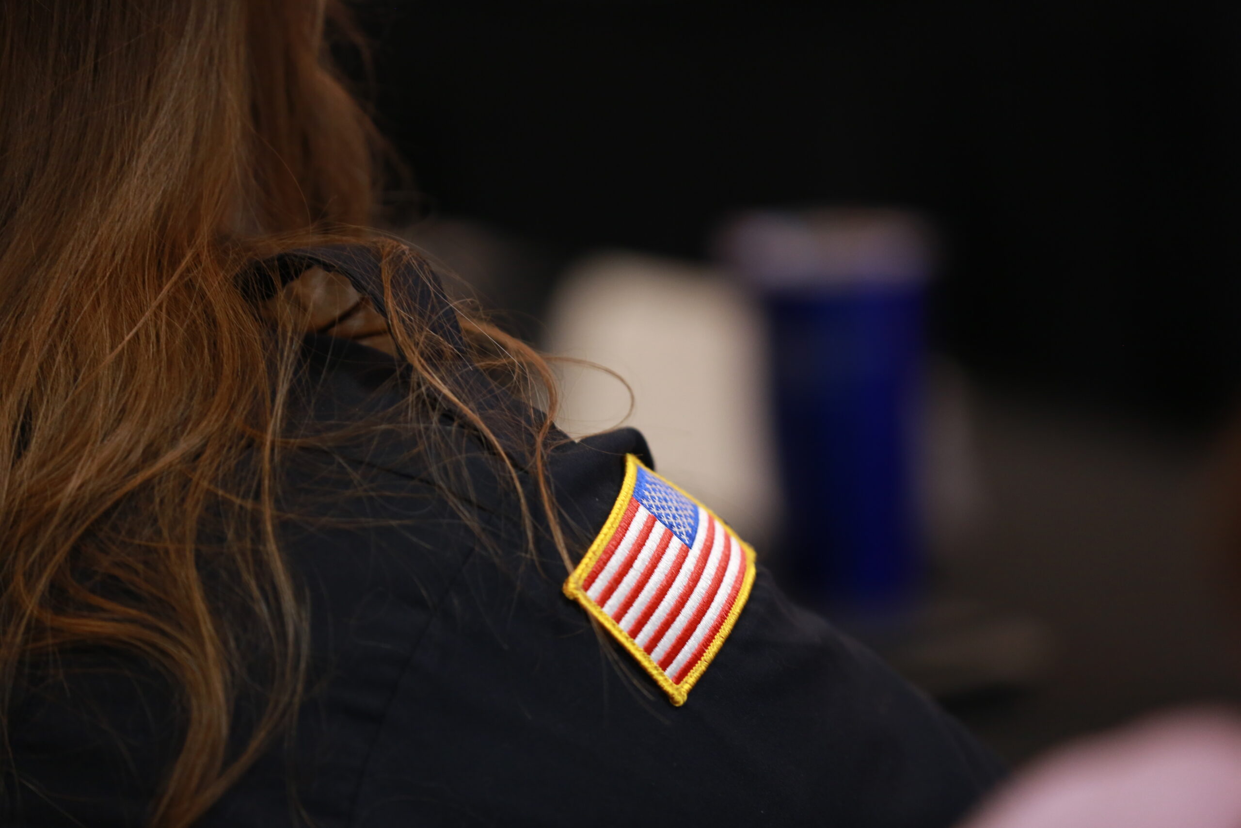 View of the meeting room across the shoulder of a member.