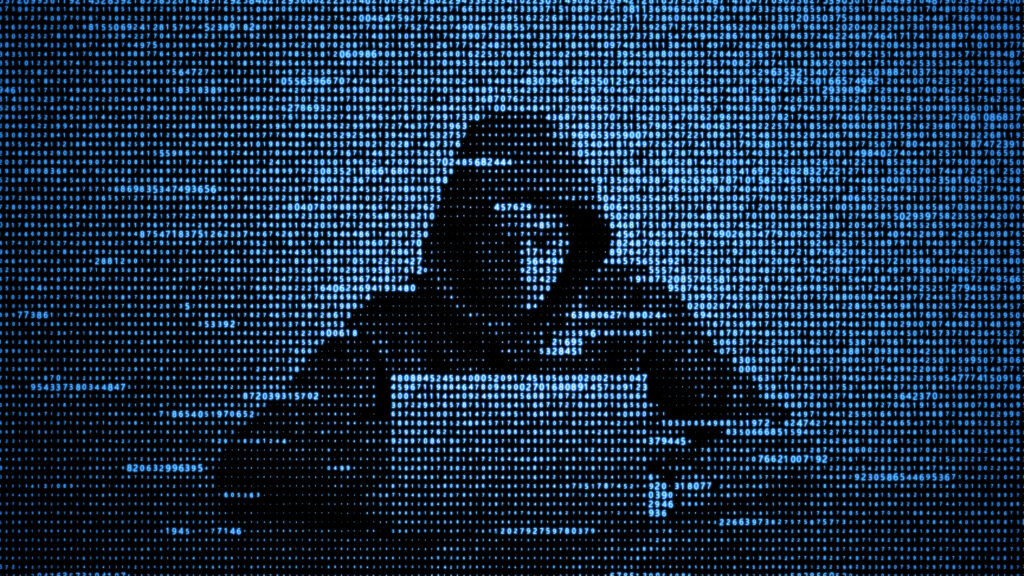 Blue illustration picturing a hacker on a laptop.