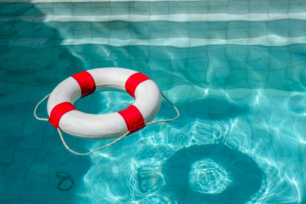 Image of a life ring in a pool on a sunny day.