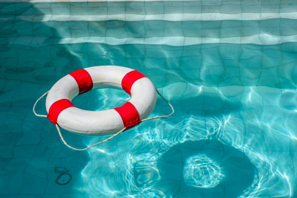 Image of a life ring in a pool on a sunny day.