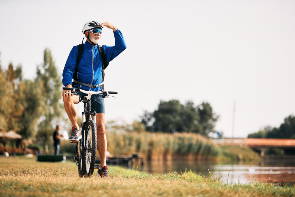 Retiree biking outside.