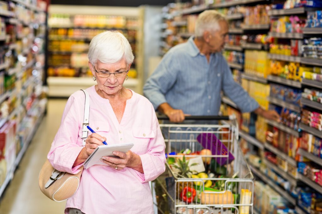 Image of two retirees grocery shopping.