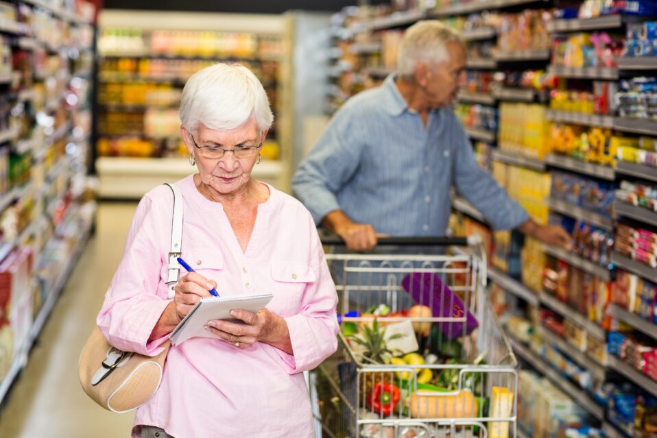 Image of two retirees grocery shopping.