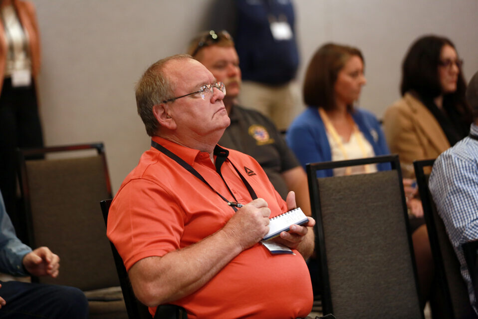 A 2025 Annual Meeting attendee takes notes during the Legislative Advisory Committee.