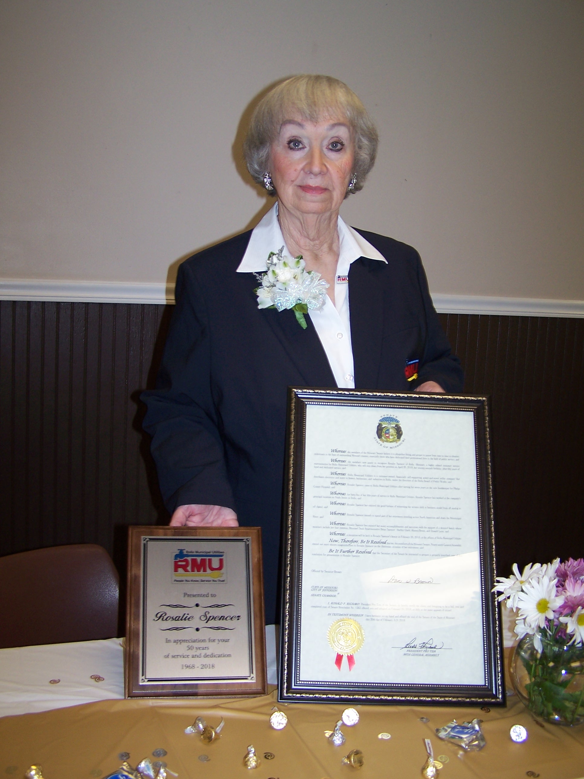 Rosalie with her appreciation plaque and her charter from the city.