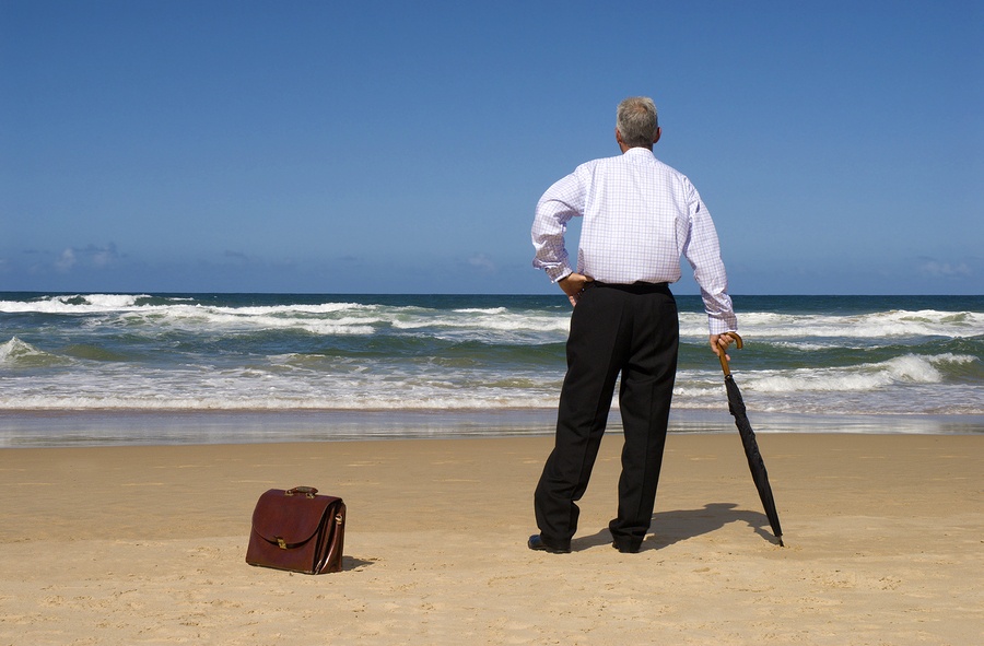 Businessman Dreaming Of Retirement On A Beach.
