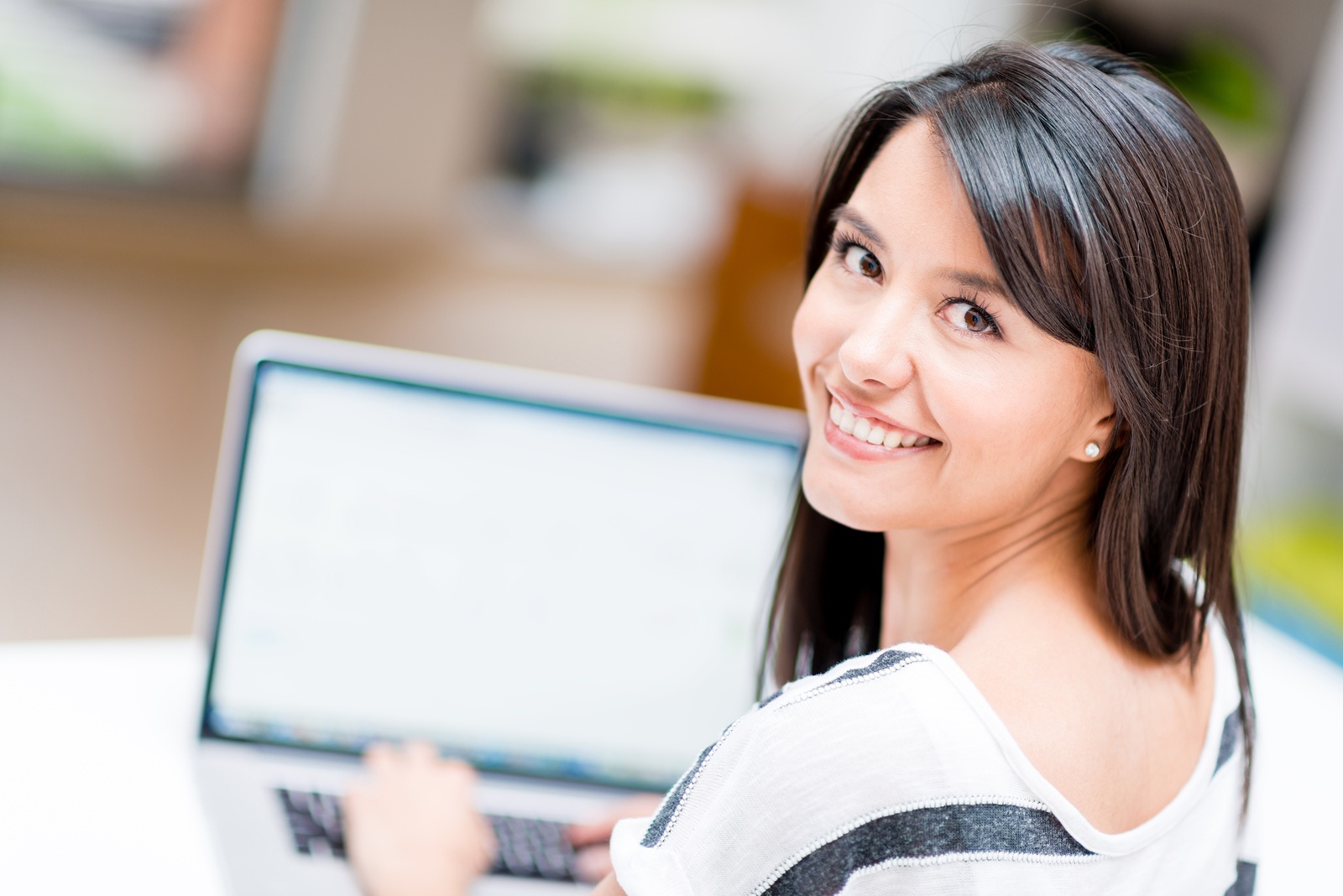 Woman working online on a laptop computer at home