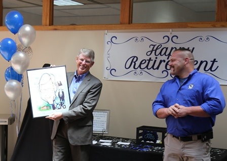 Keith being a good sport accepting his caricature from LAGERS' Board Chairman, Arby Todd, at Keith's retirement celebration.